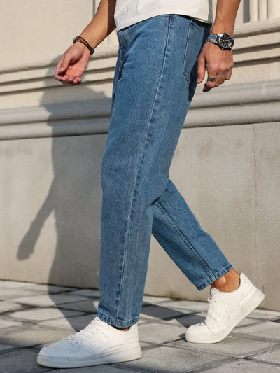 Men's jeans are made of classic blue denim fabric with a loose fit, making them an indispensable versatile item in the wardrobe.
