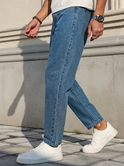 Men's jeans are made of classic blue denim fabric with a loose fit, making them an indispensable versatile item in the wardrobe.