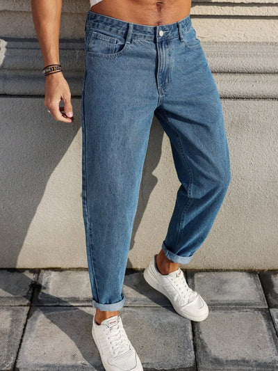 Men's jeans are made of classic blue denim fabric with a loose fit, making them an indispensable versatile item in the wardrobe.